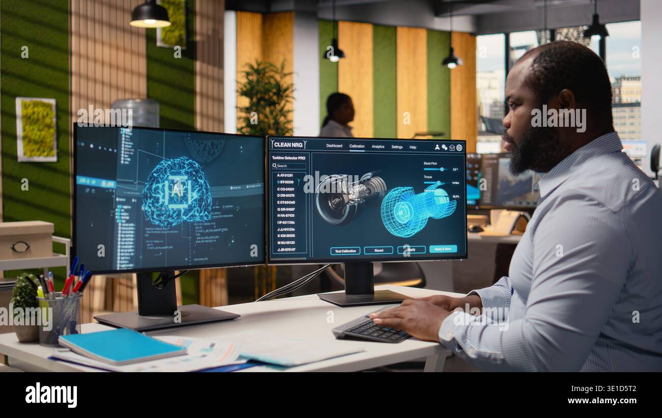 Engineer working on wind turbine simulation in office using artificial intelligence. RD department worker using AI tech and CAD program, doing renewable energy generation engineering, camera A Stock Photo