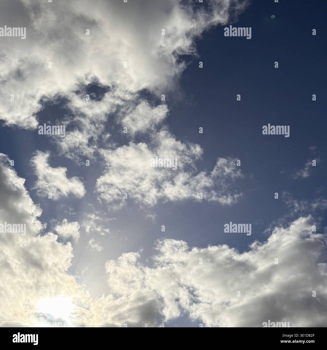 Sun's Rays Breaking Through Mixed Cloud Formations Stock Photo
