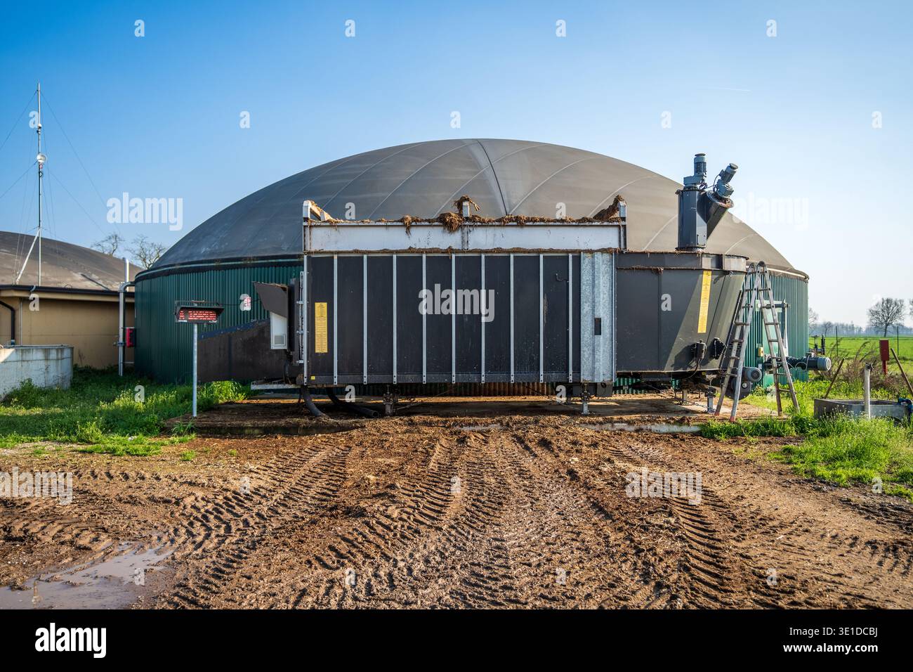 A large grey anaerobic digester dome in a modern biogas plant. In the ...