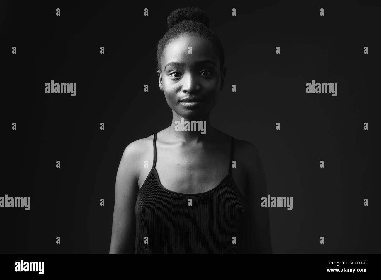 Studio shot of young beautiful African Zulu woman against black ...