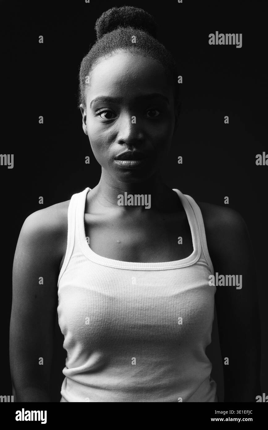 Studio shot of young beautiful African Zulu woman against black ...