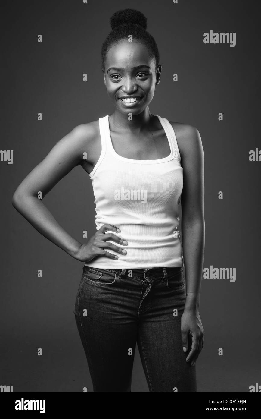 Studio shot of young beautiful African Zulu woman against black ...