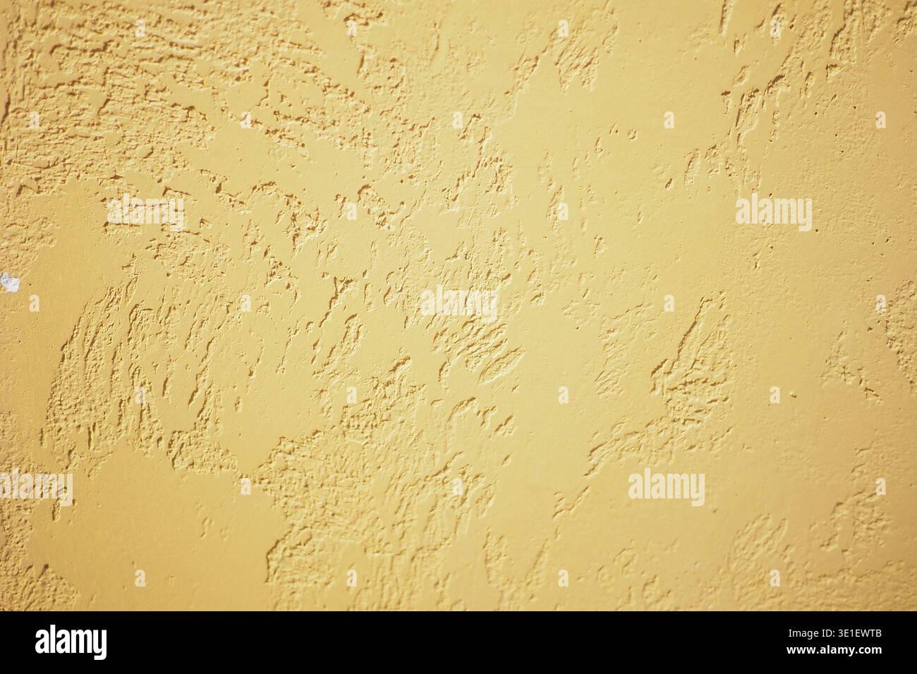 Uneven yellow textured wall surface Stock Photo