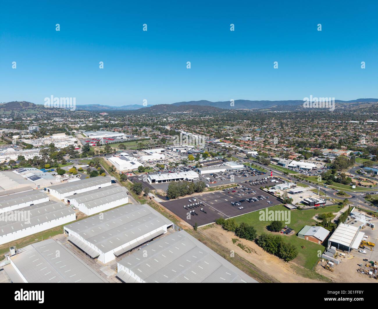 An elevated perspective reveals Wodonga, Australia, with diverse urban development including industrial, commercial, and residential areas, under a vi Stock Photo