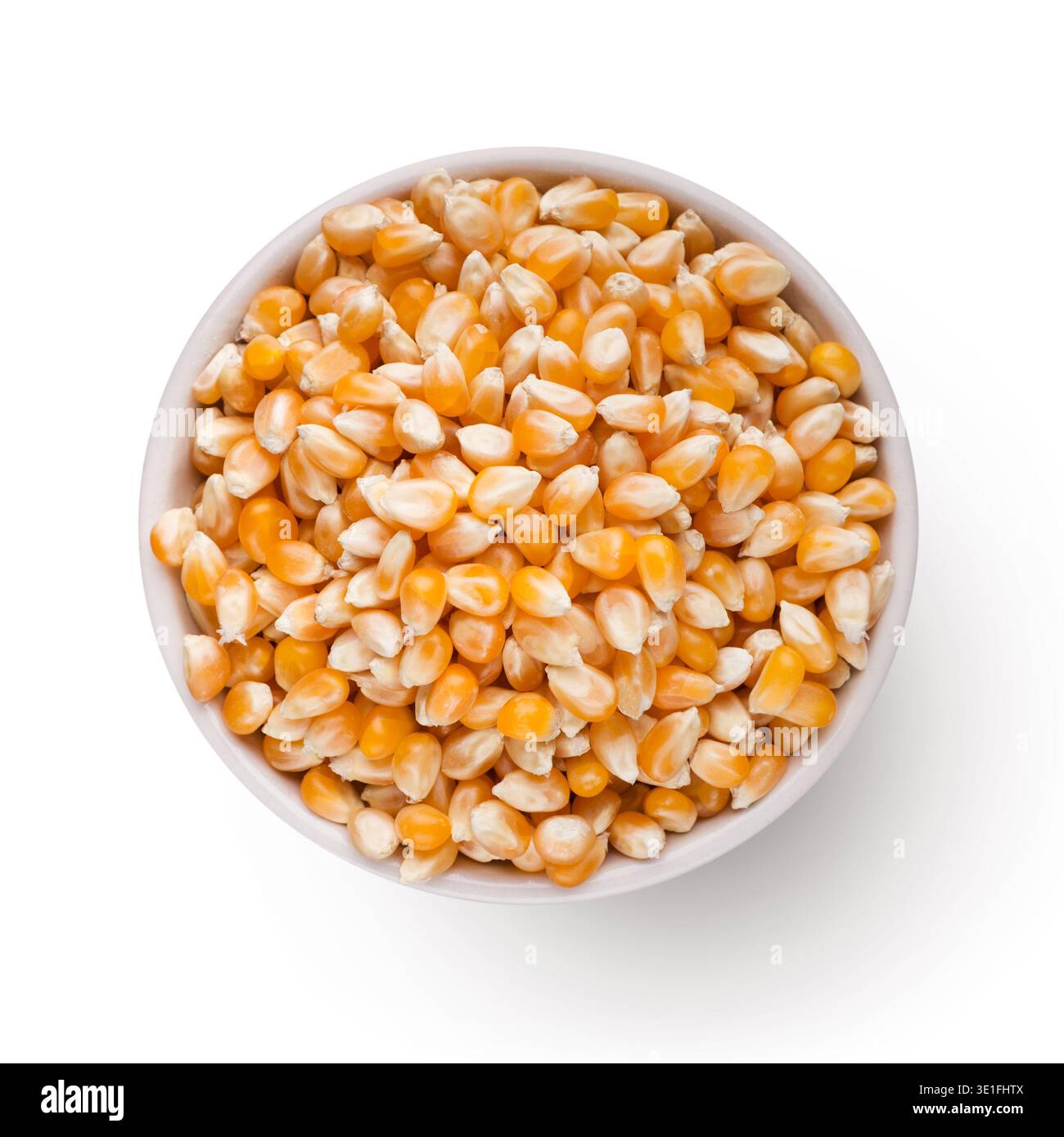 Dry corn in bowl on white background Stock Photo