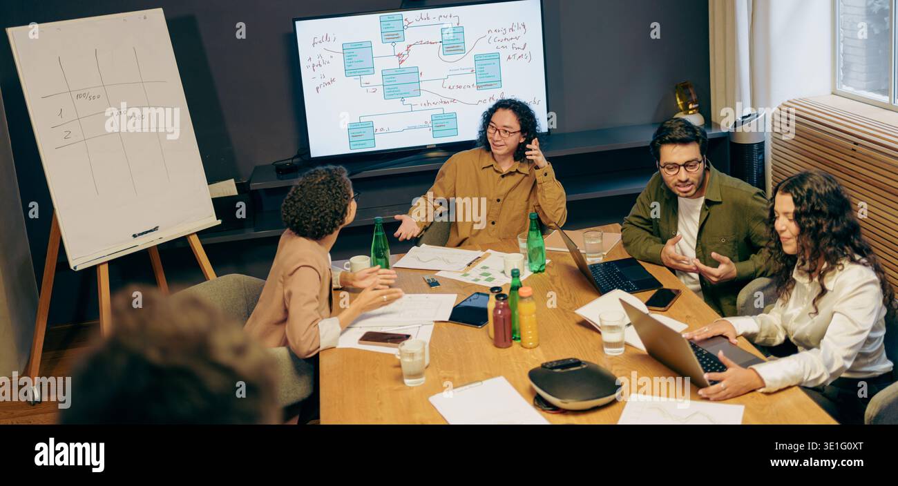 Group Strategizing Collaboratively, Collaborative Team Reviewing Project Timelines And Presentation Charts Stock Photo