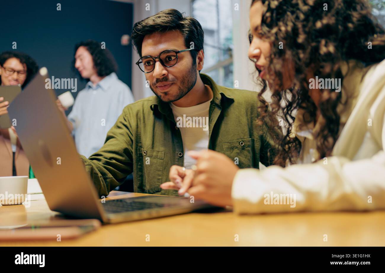 designers analyze prototype together, team members examine prototype details with notes and planning energy Stock Photo