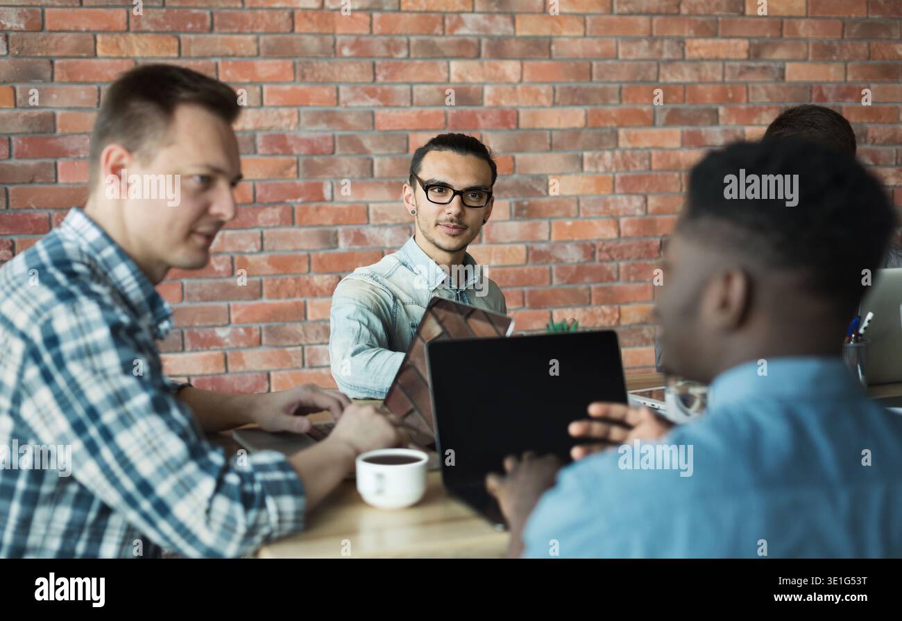 Software developers discussing marketing strategy ideas in office Stock Photo