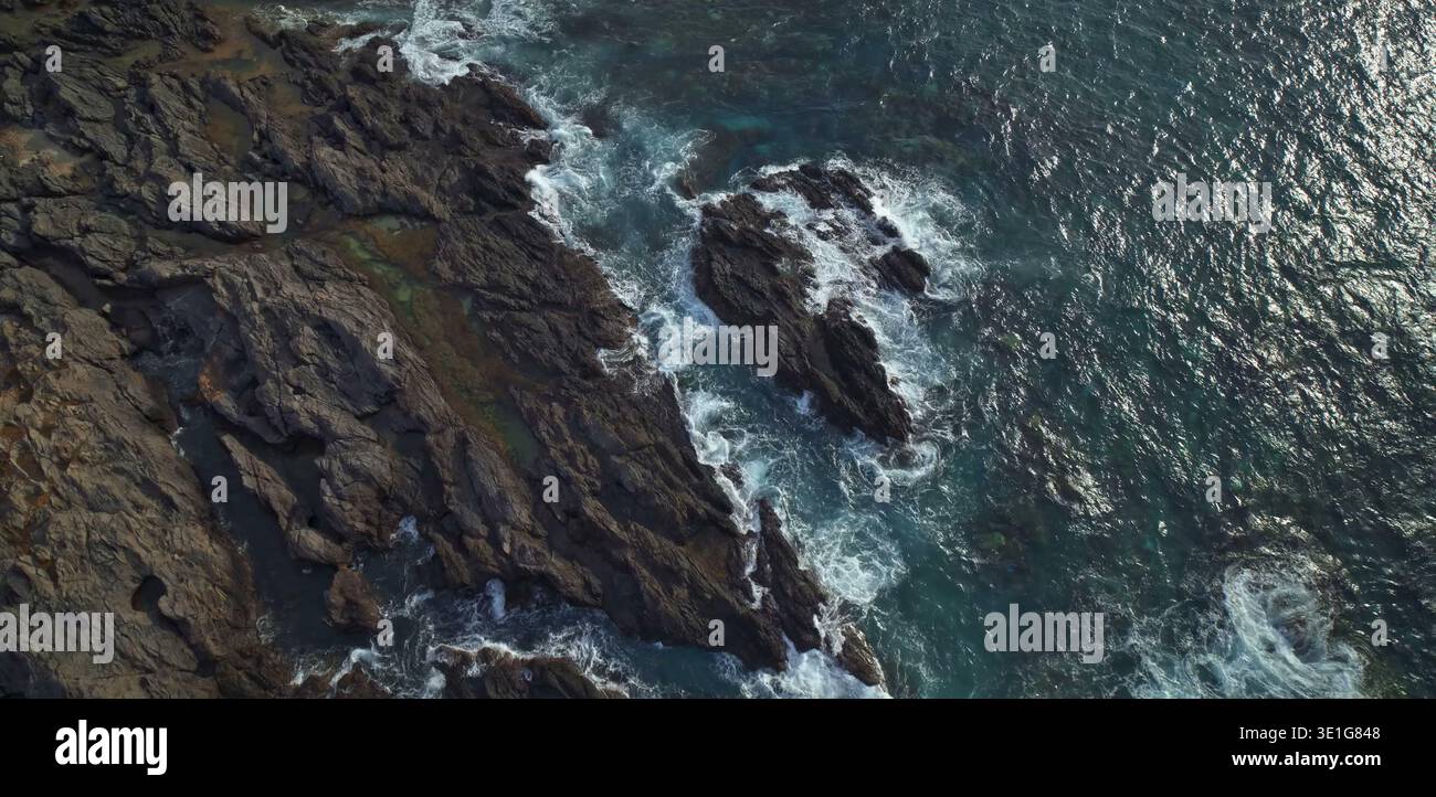 Rocky shoreline with deep blue green ocean Stock Photo