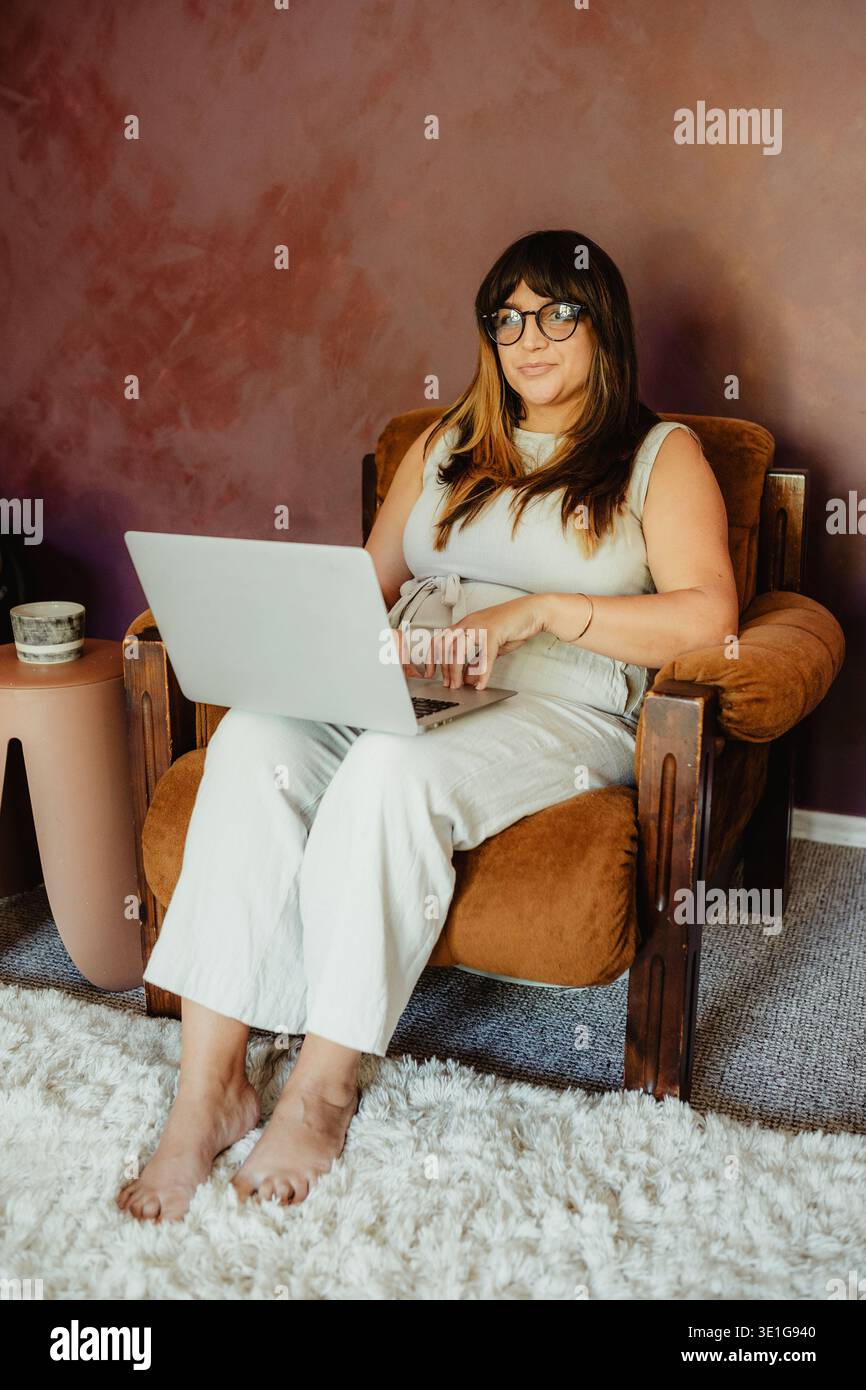 Woman working remotely from home office Stock Photo