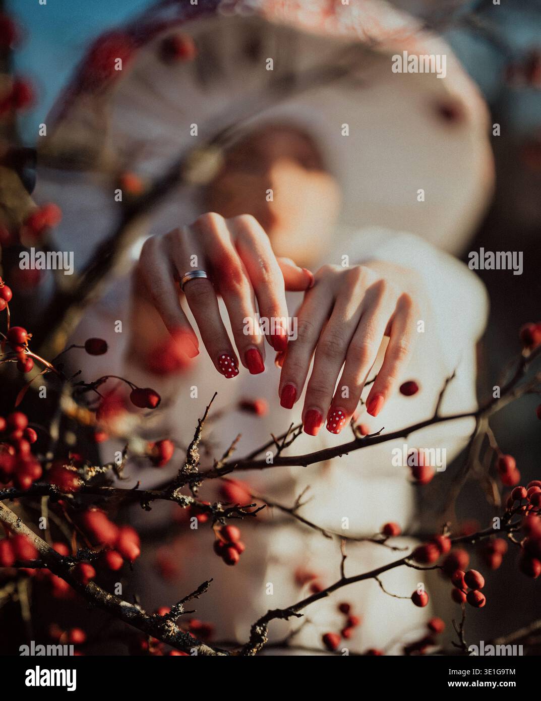 Red polka dot manicure inspired by mushroom pattern in forest Stock Photo