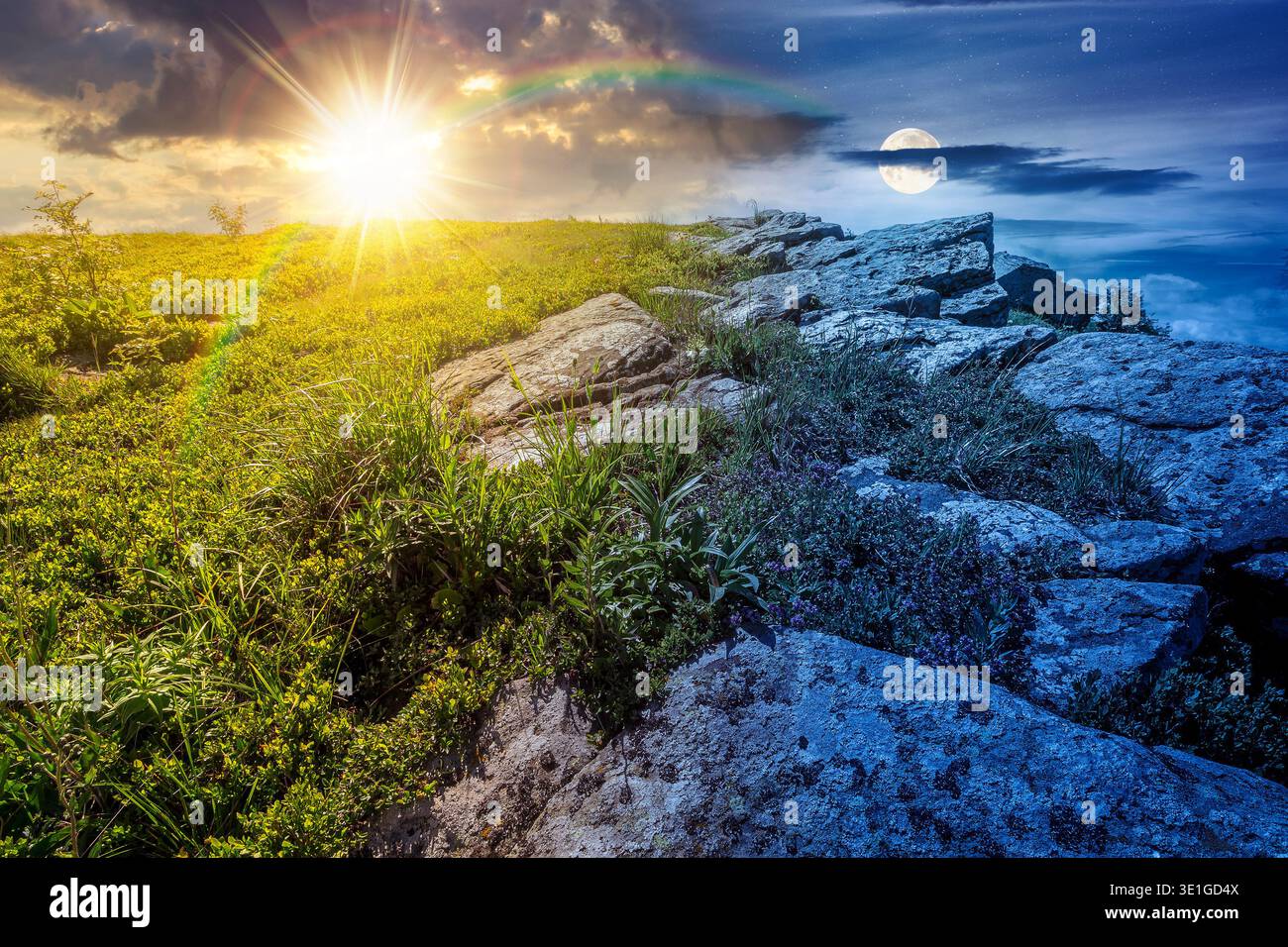 mountain landscape on summer solstice. day and night time change concept. green grass and rocks on hillside with sun and moon at twilight. beautiful v Stock Photo