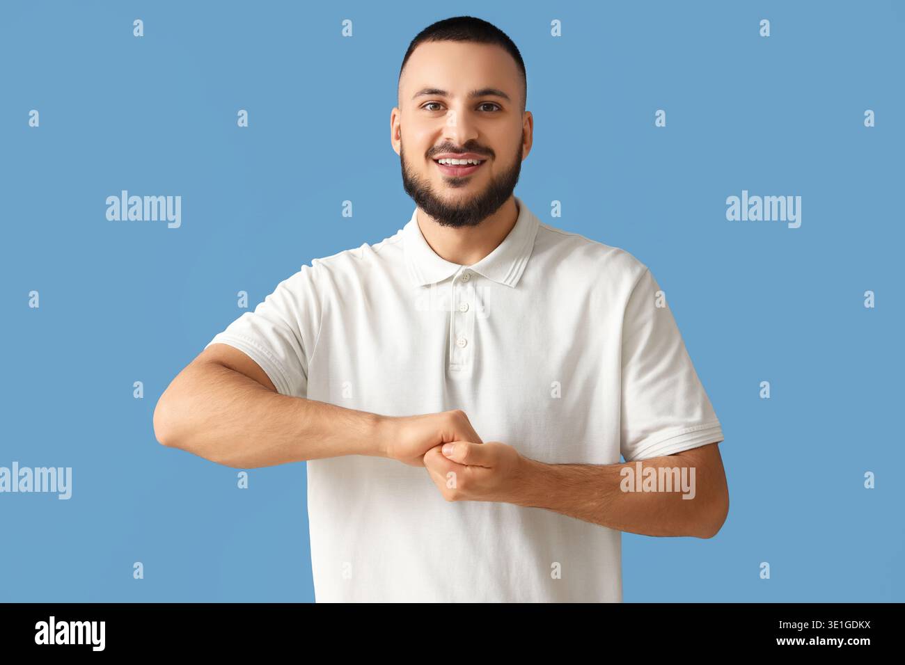 Handsome man using sign language on blue background Stock Photo