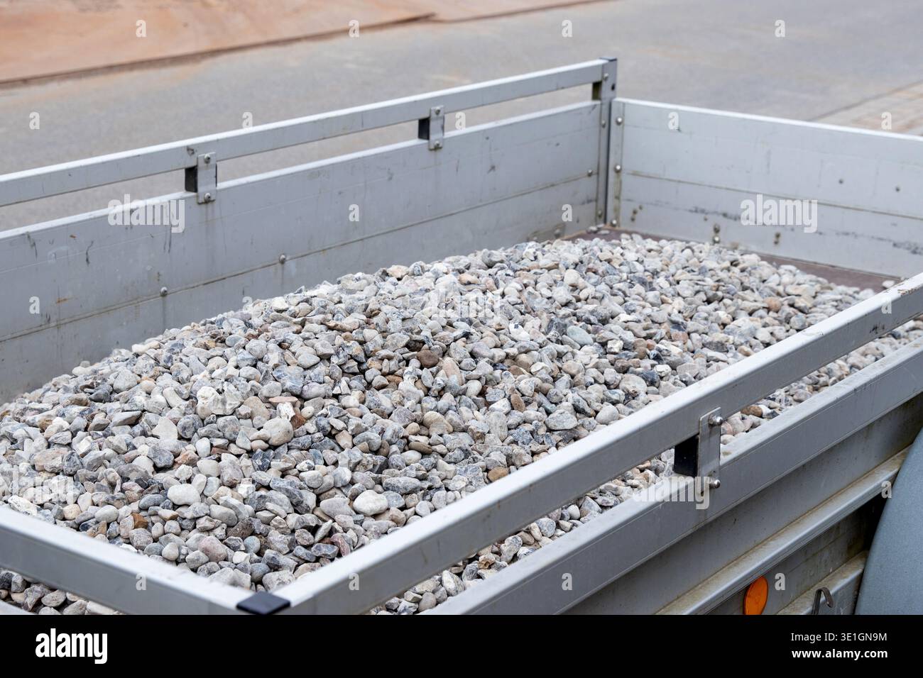 Trailer With Rocks Trailer filled with small gravel stones parked on a construction site ...