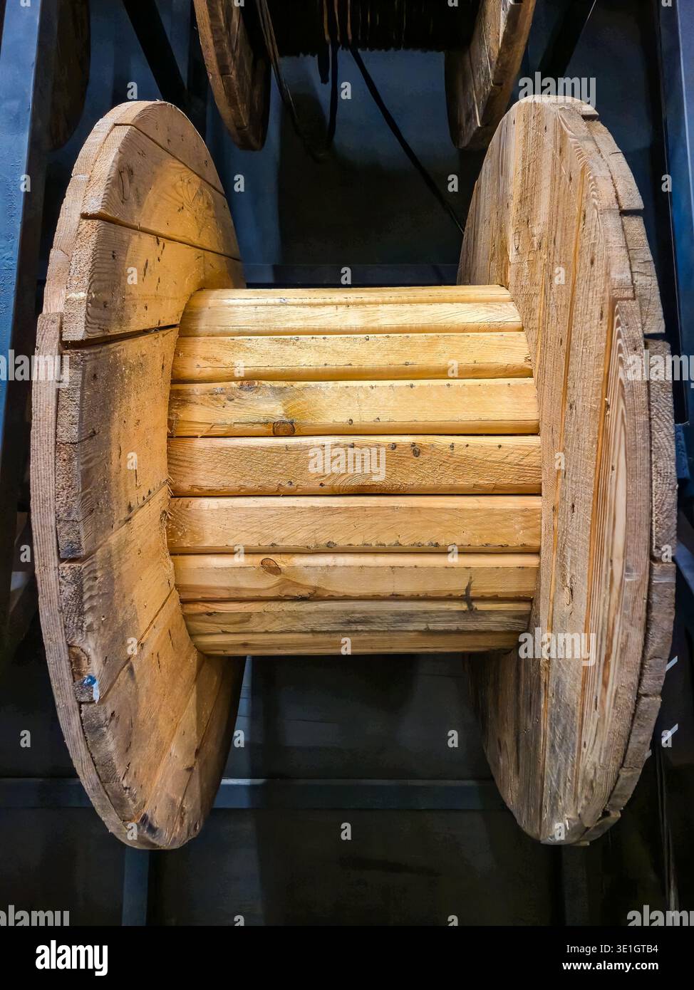 A close up view of a vintage wooden cable reel, showcasing its rustic ...
