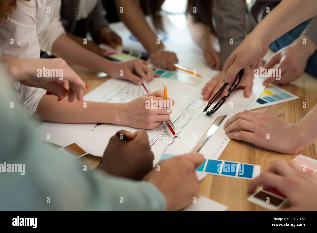 Team of architects working on construction plans Stock Photo