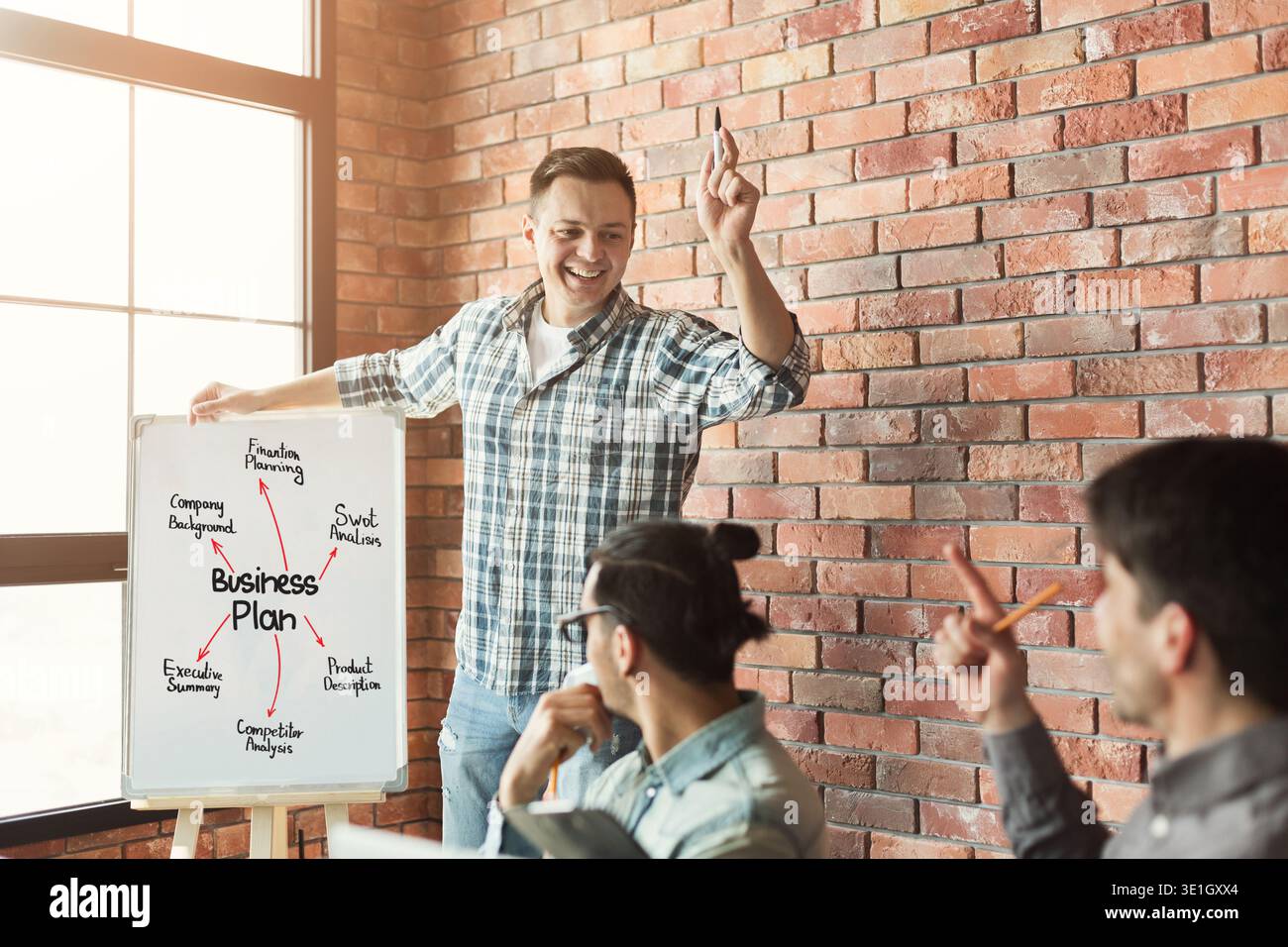 Young team discussing project in modern office Stock Photo