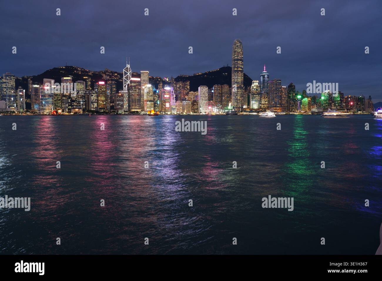 Hong Kong cityscape with Victoria Harbour. Night city skyline view from Kowloon in direction of Central Hong Kong. Stock Photo