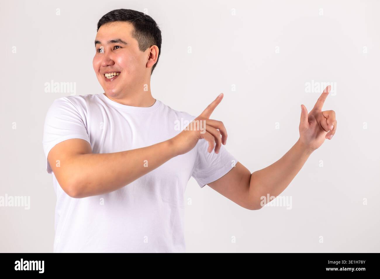 Happy man pointing with both hands to the side Stock Photo