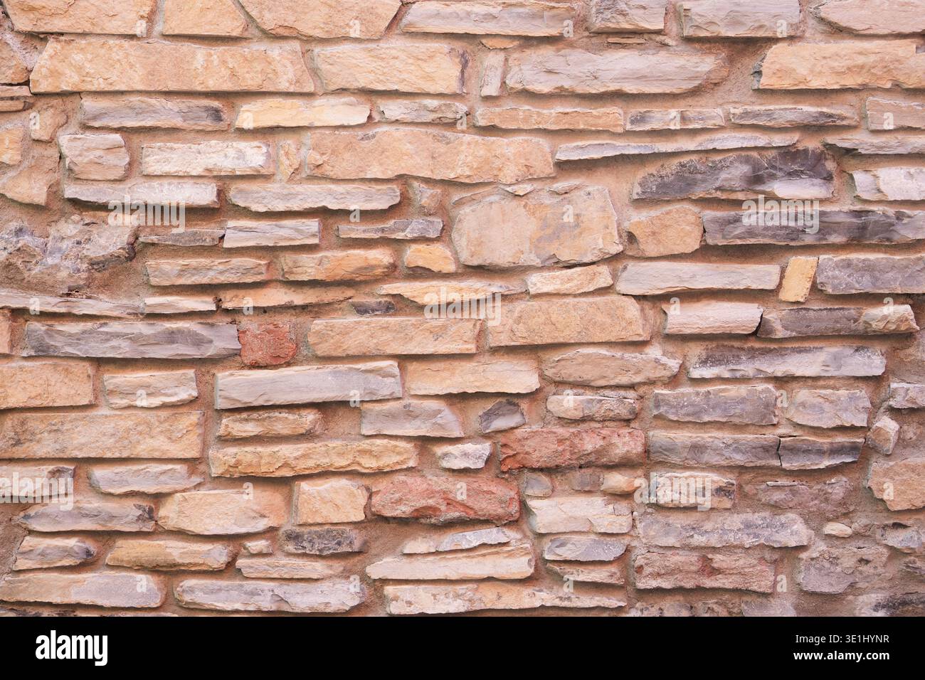 The beige sandstone brick masonry wall texture rustic old background facade Stock Photo
