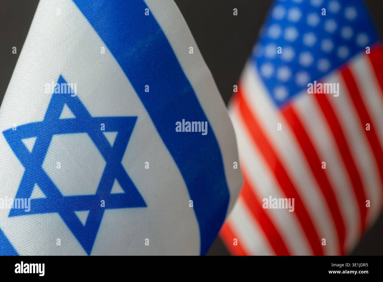 Close-up of the Israeli flag, with the U.S. flag in the background Stock Photo