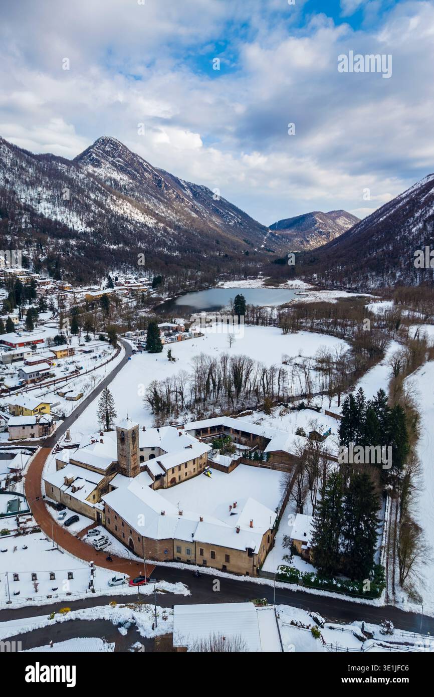 Aerial view of a cloudy winter day over Lago di Ganna. Ganna, Parco Regionale del Campo Dei Fiori, Valganna, Varese Province, Lombardy, Italy. Stock Photo