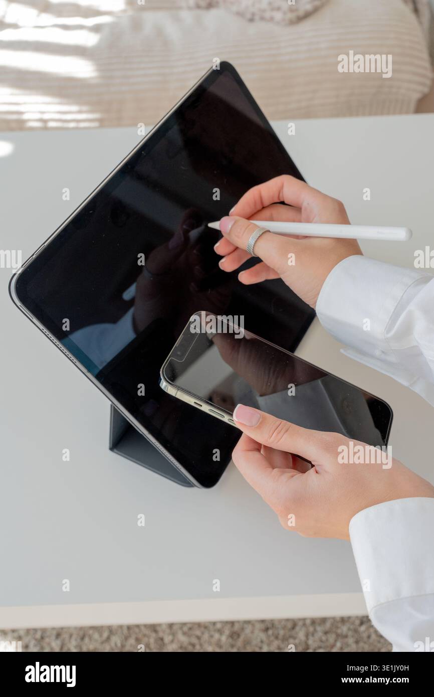 Woman Using Stylus on Tablet and Checking Phone – Digital Creativity, Modern Technology Stock Photo