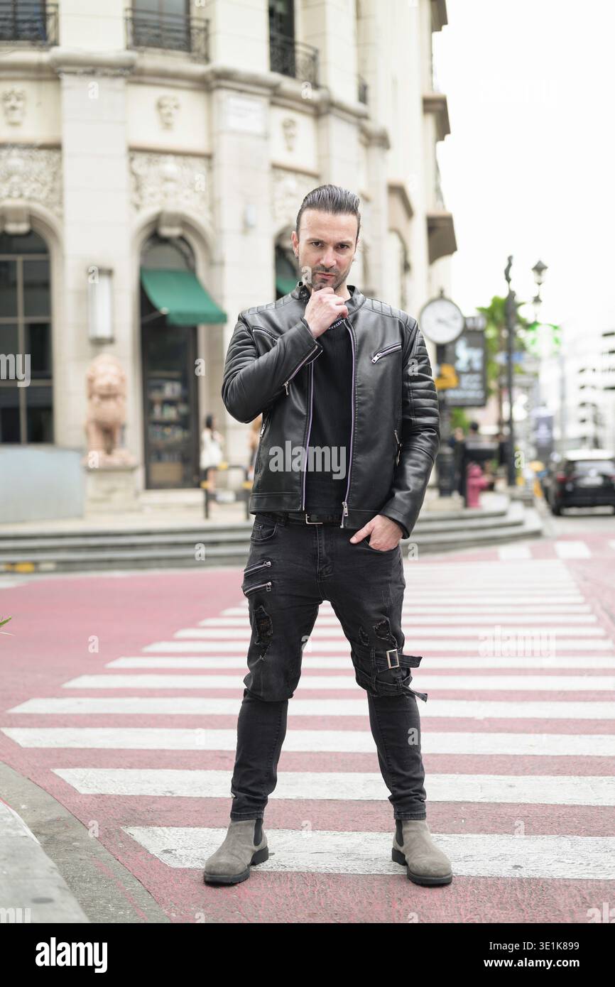 Confident bearded man wearing black leather jacket Stock Photo