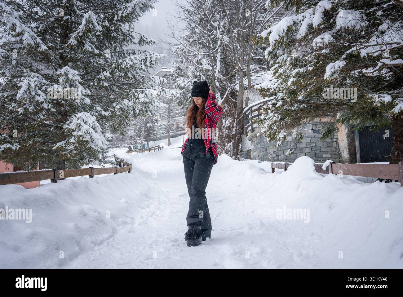 Young woman on snow path at San Domenico ski resort, Italian Alps Stock Photo