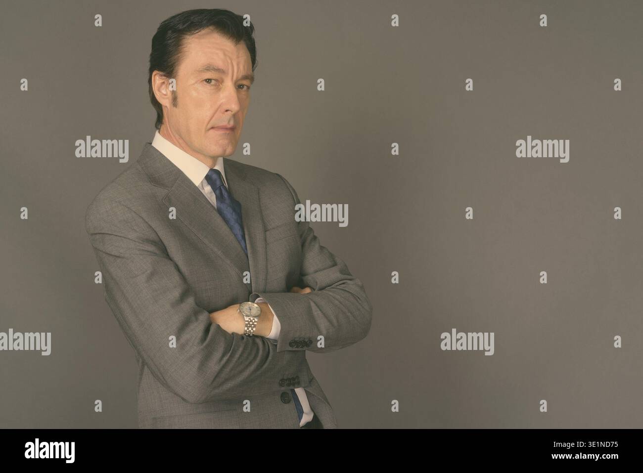 Studio shot of mature handsome businessman against gray background Stock Photo