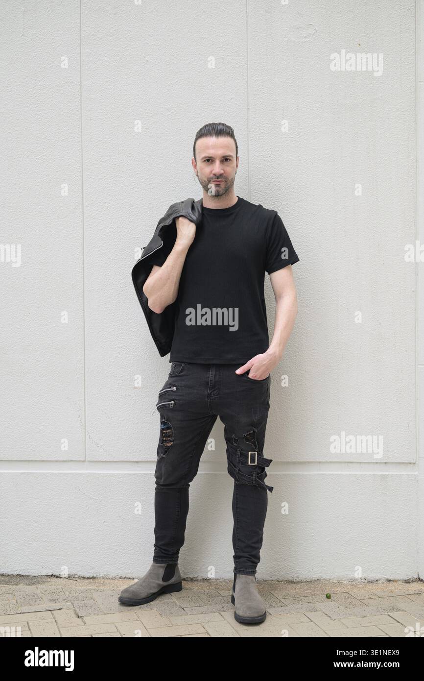 Confident bearded man wearing black leather jacket Stock Photo