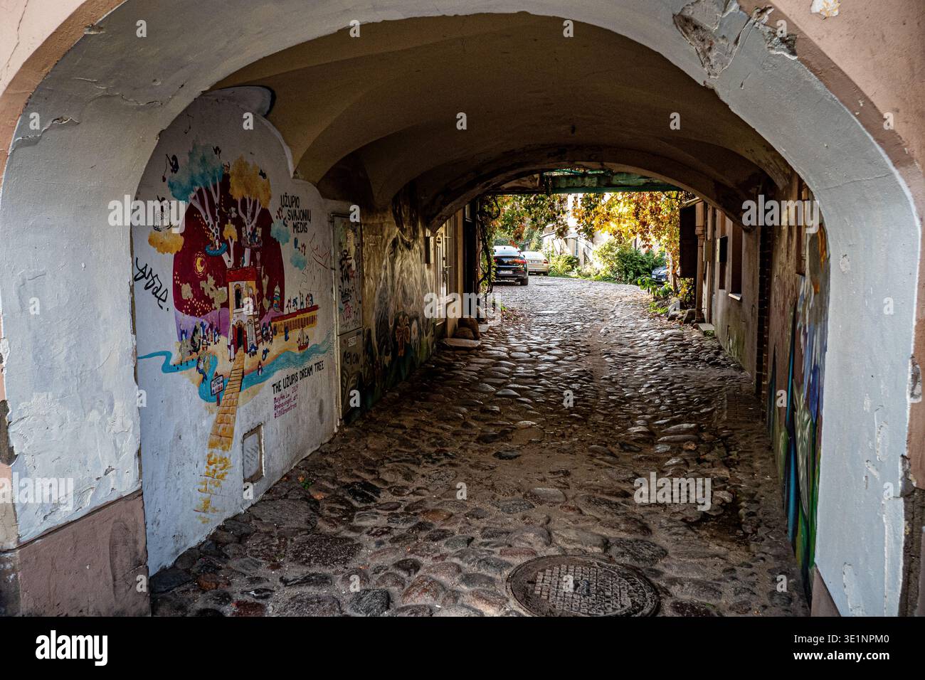 Arched cobblestone passageway with graffiti in Old Town, Vilnius, Lithuania Stock Photo