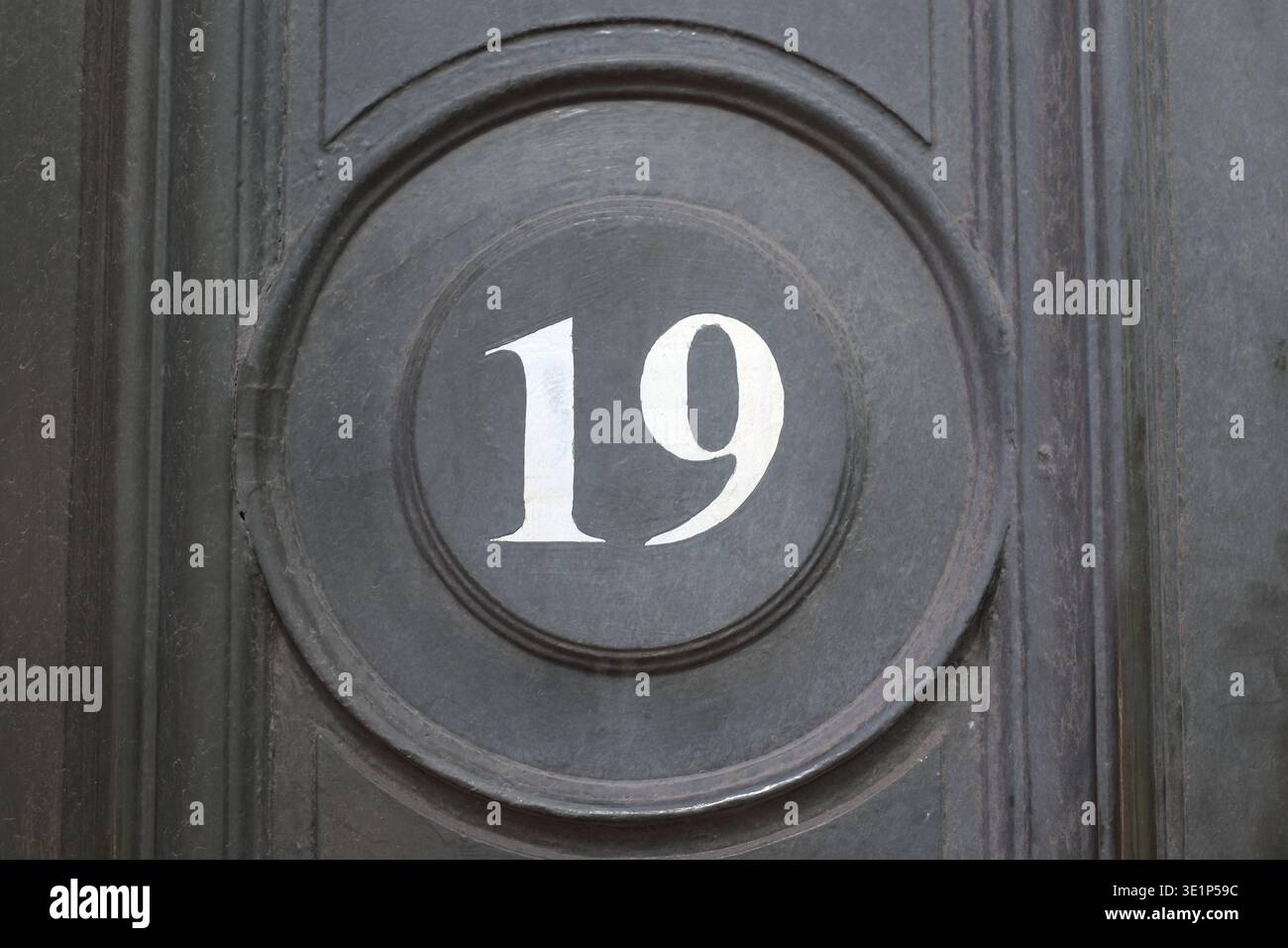 19 door number, white text on black background Stock Photo