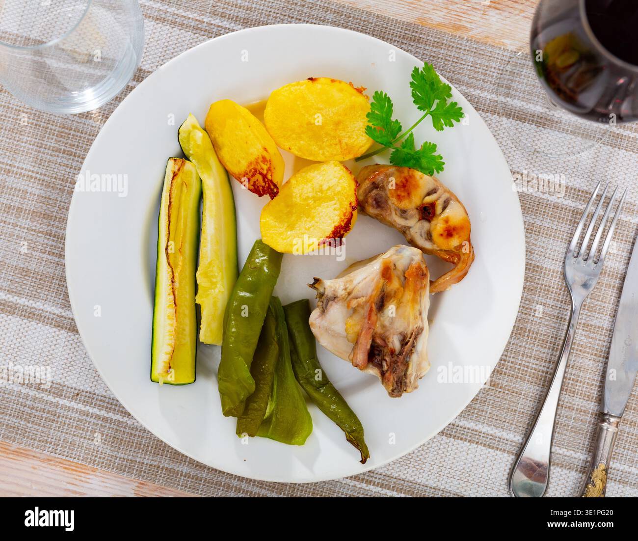 Rabbit meat with vegetables served on plate Stock Photo