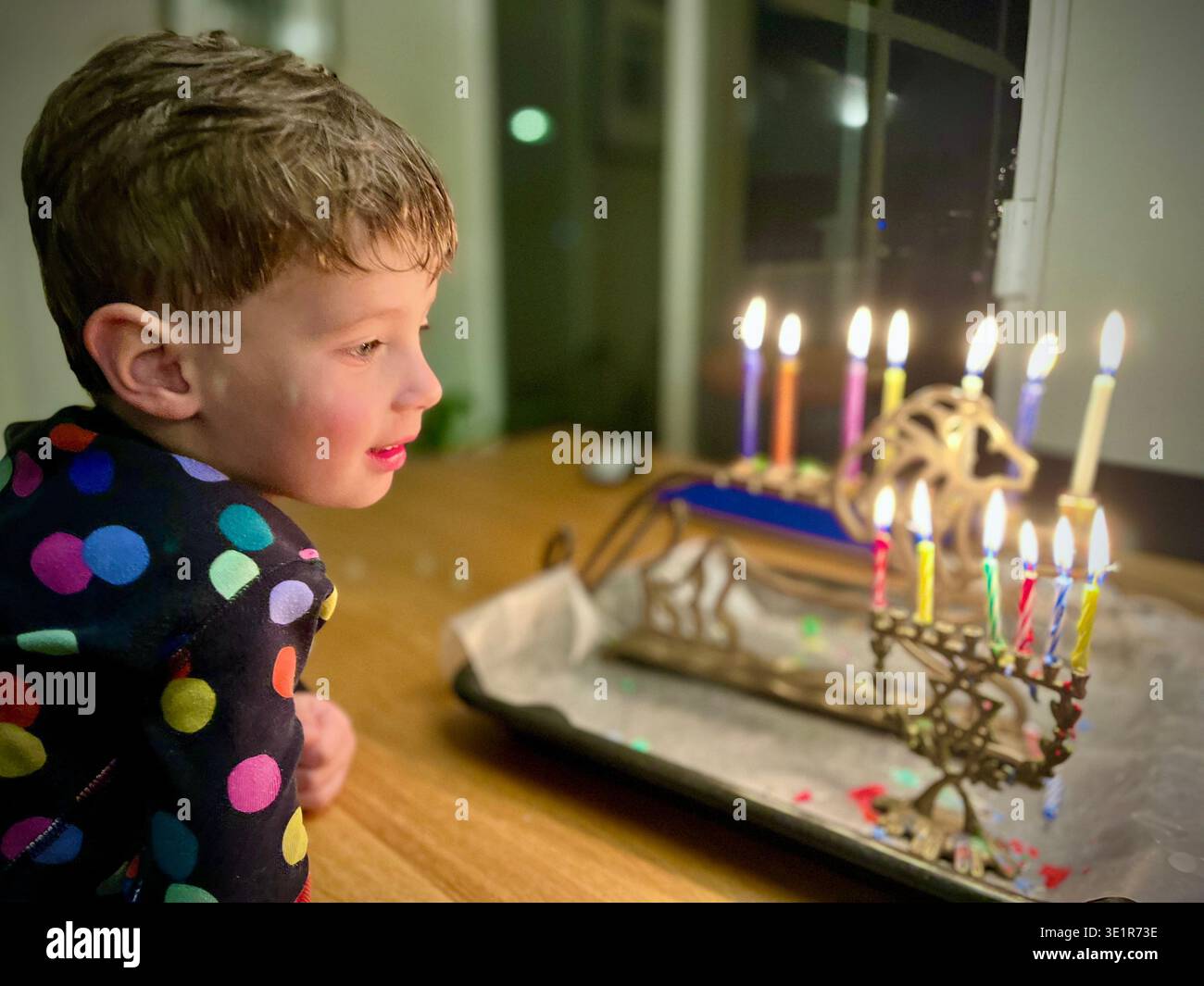 Three year-old boy looking at menorahs. - Smartphone Captured Stock Image