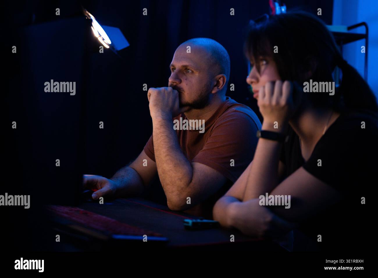 Concentrated Couple Working at Night Stock Photo