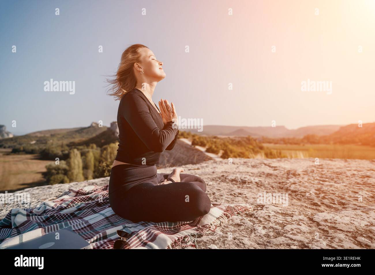 Woman Meditating on a Mountaintop Stock Photo