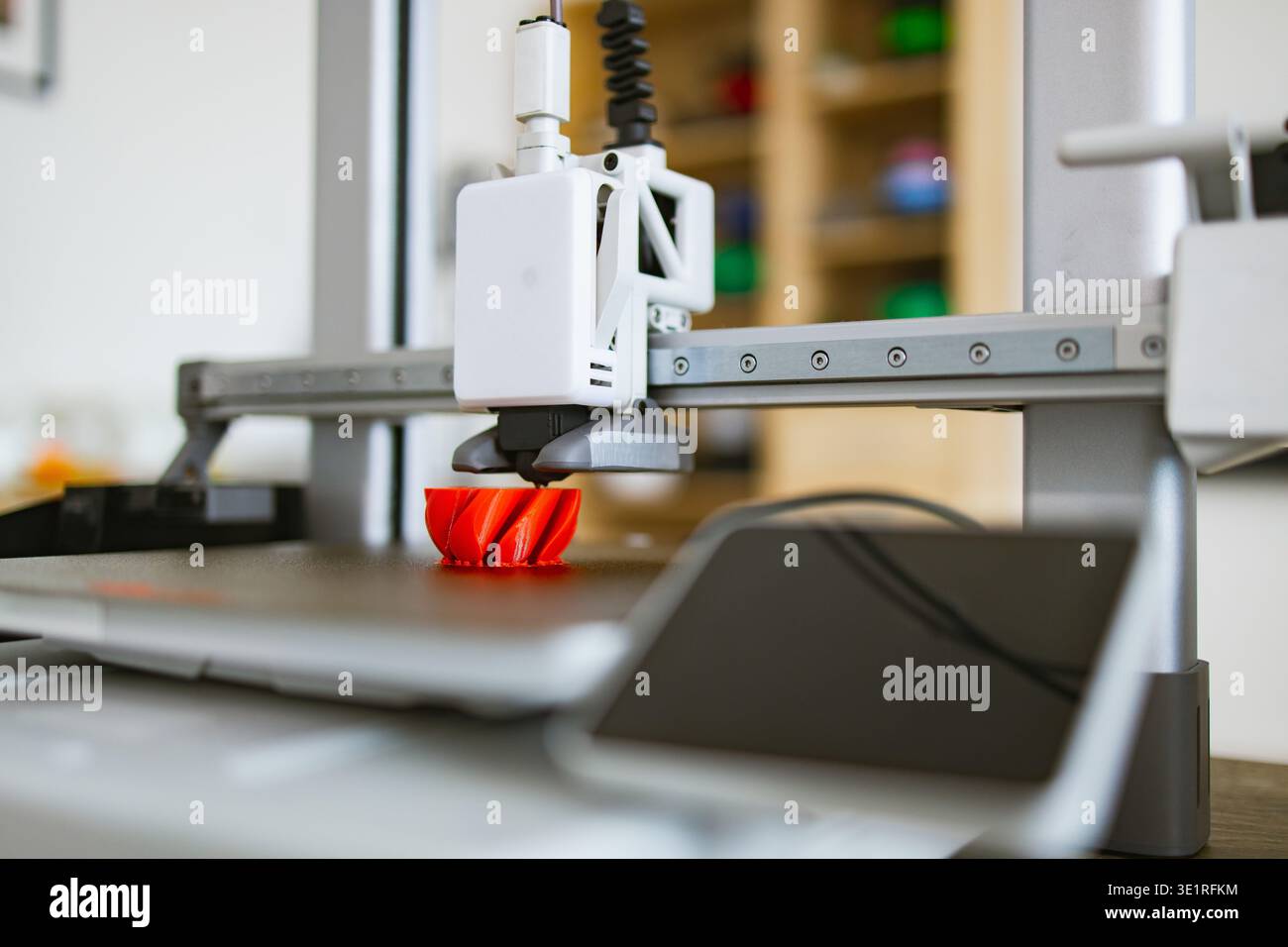3D Printer Creating Red Object Stock Photo