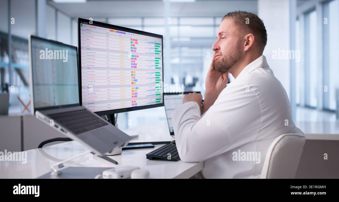 Physician Frustrated While Navigating Hospital Computer Systems Stock Photo