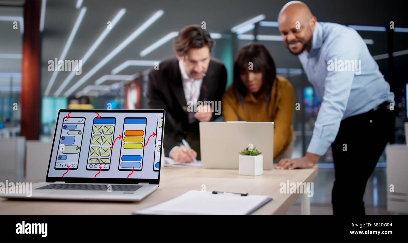 Diverse Team Collaborates On App Design, Developing User-friendly Interfaces. The Web Developer Studies UI On A Laptop Stock Photo