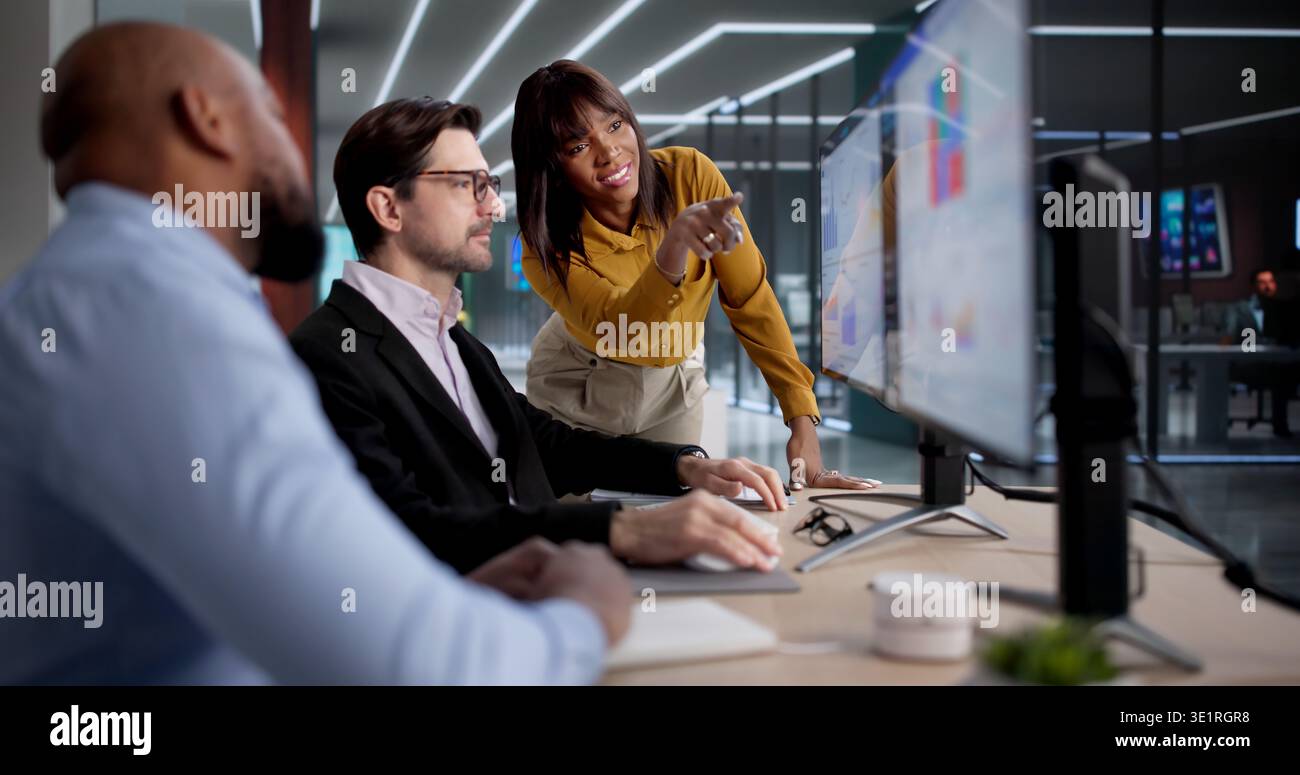 Diverse Team Using Computers To Analyze Data And Manage Business Performance, Possibly As Analysts, Managers Stock Photo