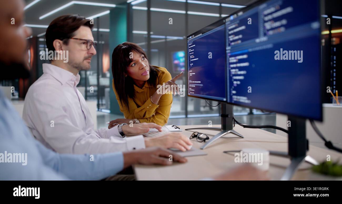Diverse Team Of Software Developers Coding, Collaborating, And Leading Projects. Many Programmers, Engineers Stock Photo