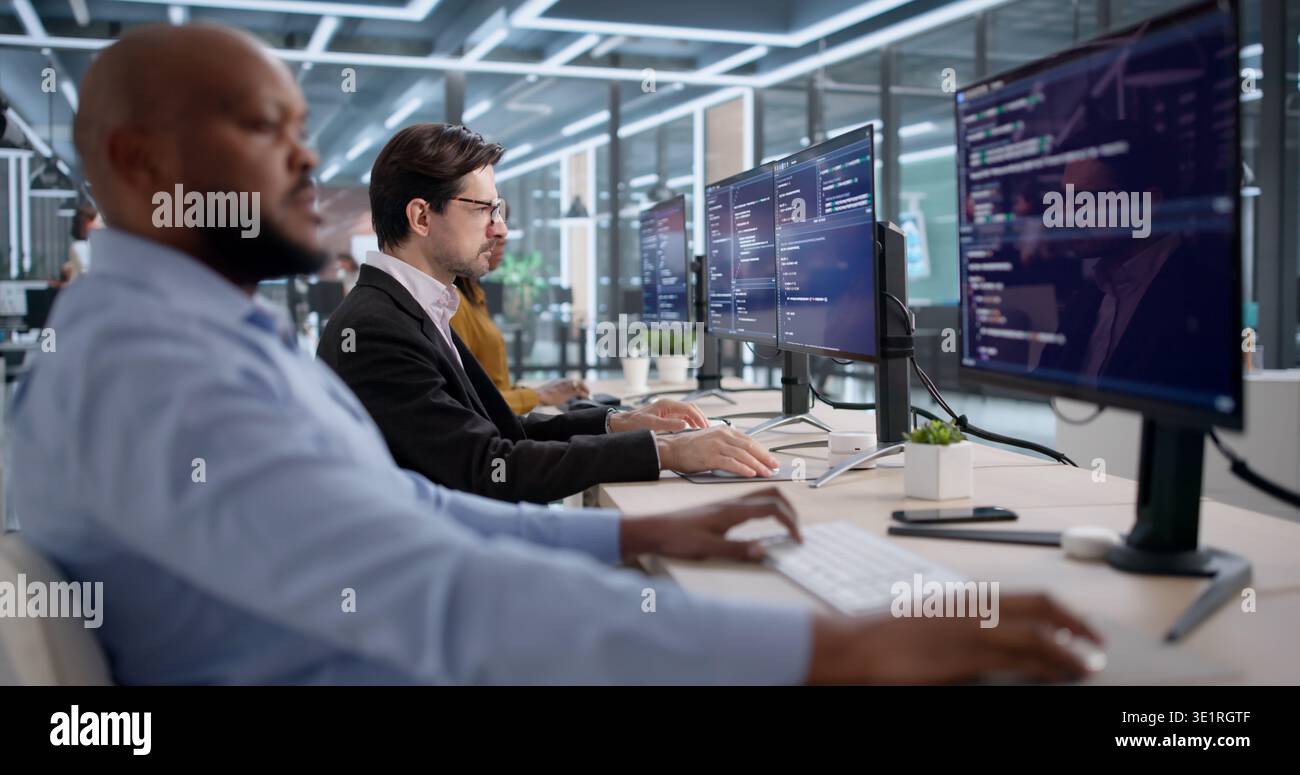 Diverse Team Of Software Engineers Coding Security Programs In An Office. People Developing Computer Systems Stock Photo