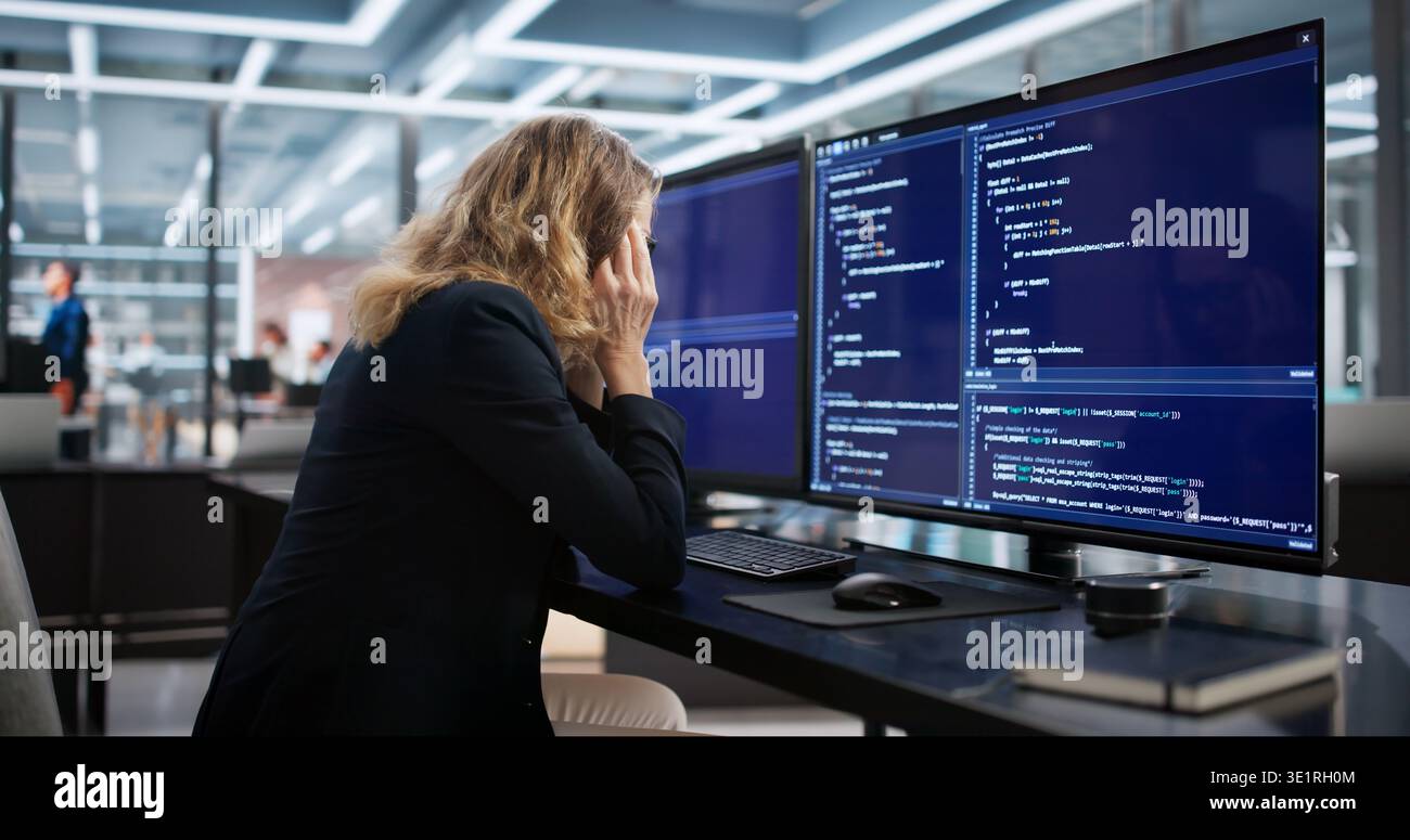 The Sad Web Developer At Her Boring Desk Coding Software Stock Photo