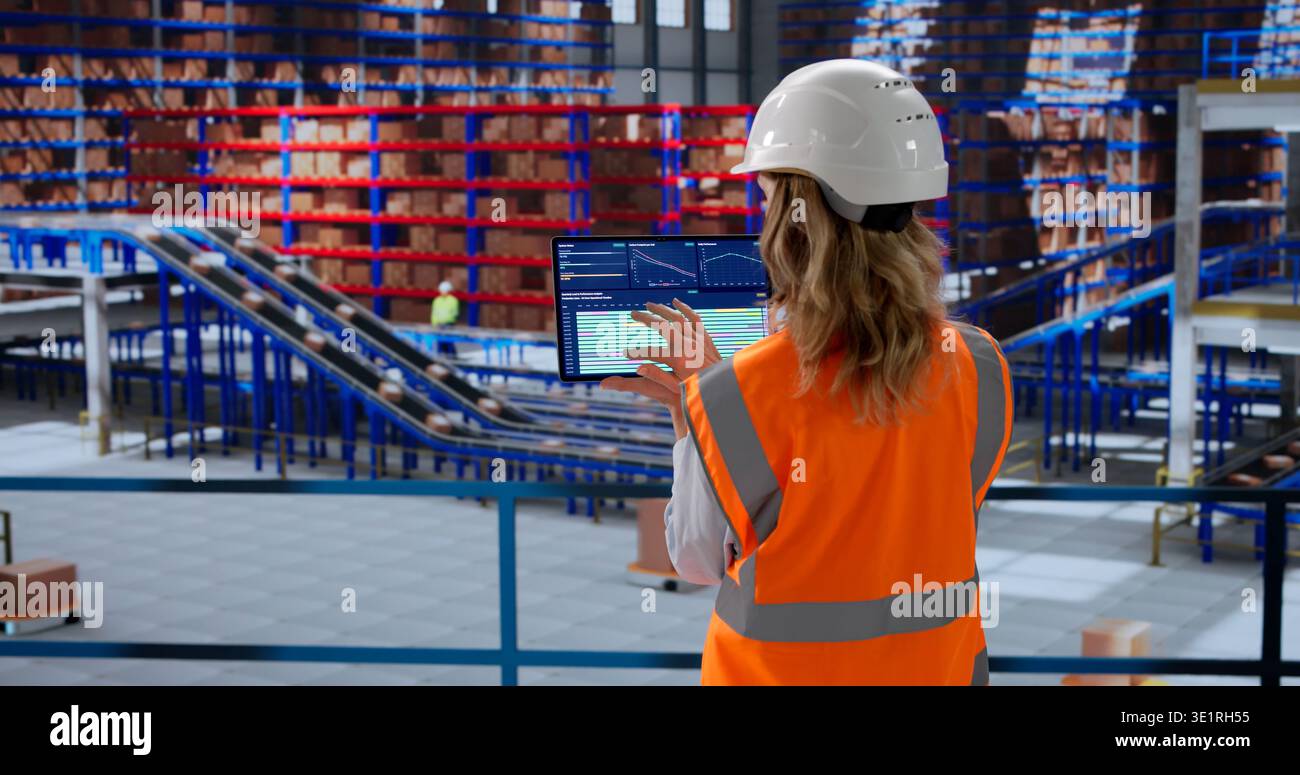 Analyzing Inventory Data On Tablet Dashboard In Warehouse Automation Center Stock Photo