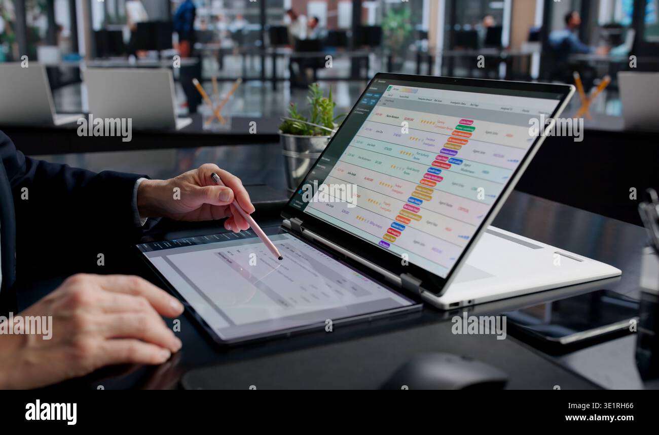 Corporate Accountant Analyzing Invoices And Payroll Data On Office Computer Stock Photo