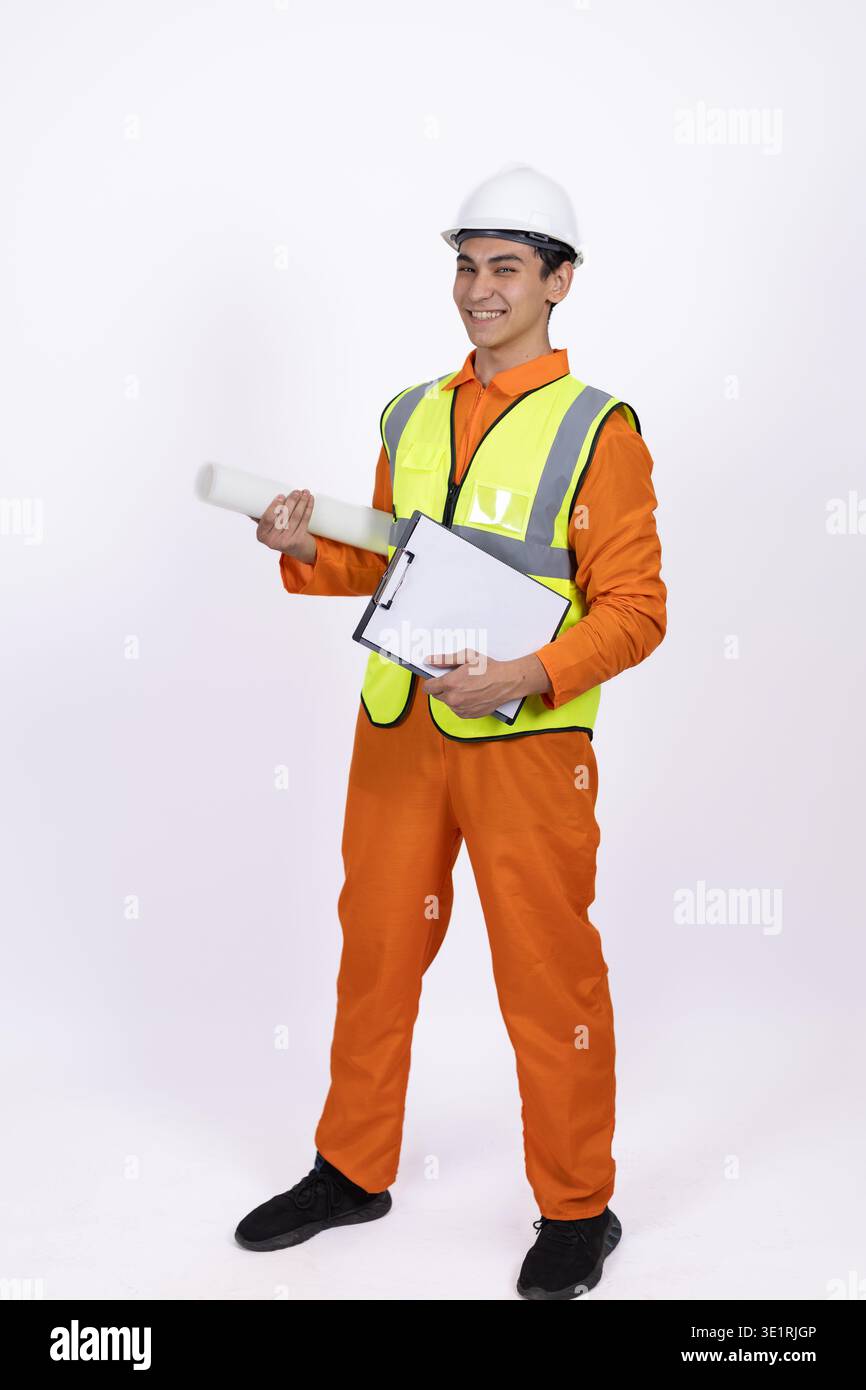 Construction worker pointing and holding a tablet Stock Photo