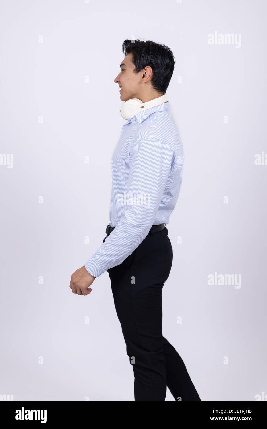Young professional man walking in side profile view Stock Photo