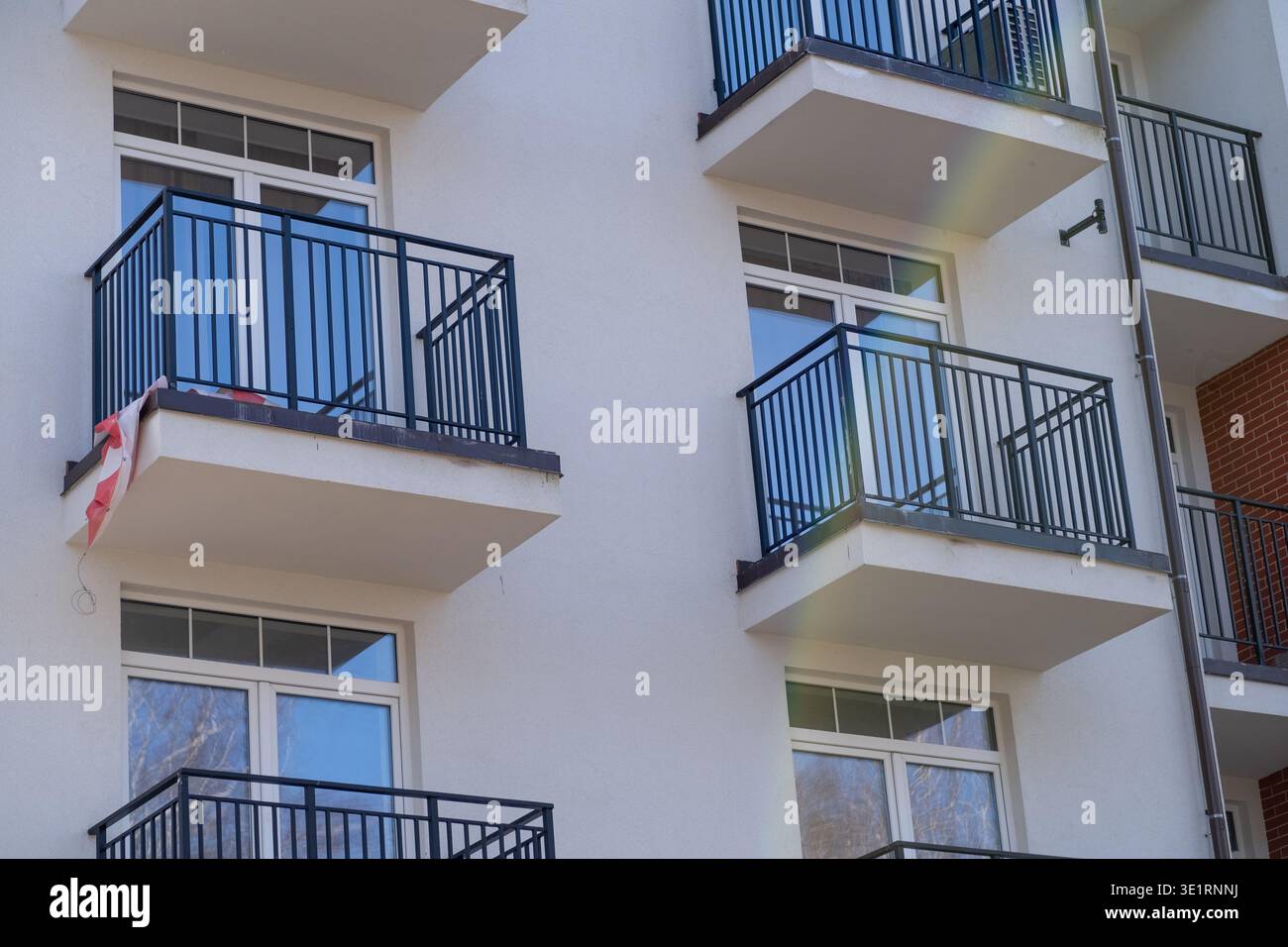 Modern apartment building facade with multiple balconies and large ...