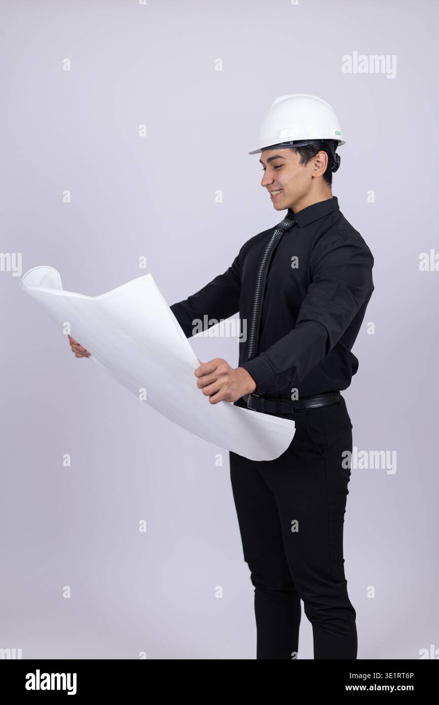 Professional engineer holding building plan and looking Stock Photo